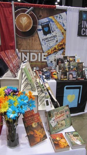 ALA Midwinter 2015 — Foreword Reviews Indie Press Collective booth with coffee, flowers, and book display