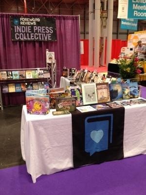 BEA 2015 Indie Press Collective booth — display table with books and purple draping